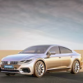 Silver Volkswagen Sedan Driving on Desert Road with Clear Blue Sky