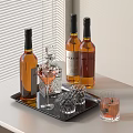 Amber Liquor Bottles and Assorted Glasses on Black Tray by White Blinds Table