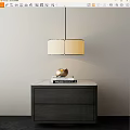 Modern Pendant Chandelier Hanging Above Dark Wood Cabinet With Marble Top And Decorative Sphere