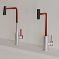Two Modern Red And Silver Kitchen Faucets Mounted On White Countertop 3d model
