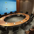 Modern Conference Room With Round Table Black Office Chairs And Blue Projector Screen