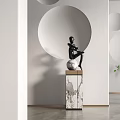 Modern Black Sculpture Seated On Sphere With Marble Pedestal And White Wall Circular Design