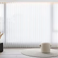 White Vertical Curtains in Modern Bright Room with Wooden Floor Round Stool and Floor Lamp