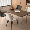 Modern Interior Wooden Dining Table Set With Black White Chairs Fruit Bowl And Open Book