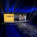 Grand voco Hotel Launch Event Stage With Backdrop Screen Architectural Images And Blue Lighting