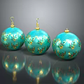 Three Turquoise Christmas Ornaments With Gold Leaf Patterns And Shiny Reflections