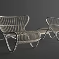 Pair of Modern Rattan Lounge Chairs With Metal Frame And Curved Backrest Design