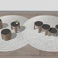 Three Wooden Round Side Tables On Woven Rug With Small Plant