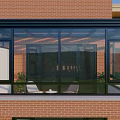 Glass Sunroom Attached To Red Brick Building With Black Frame And Glass Windows