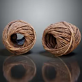 Two Brown Coiled Twine Balls Placed On Black Reflective Surface 3d model