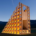 Scenic Illuminated Wooden Observation Deck With Geometric Design Over Grassland At Twilight Mountain Backdrop