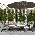 White Wicker Outdoor Sofa with Umbrella Chairs and Coffee Table in Lush Patio Garden