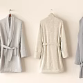 Plush Towel Bathrobes Hanging On Wall In Light Gray Beige And Dark Gray