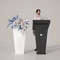 Black Podium with Huawei Logo and Man Standing Near White Vase with Blue Pink Flowers
