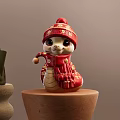 Red Snake Shaped Art Installation With Knitted Hat Scarf And Gold Patterns On Wooden Base