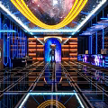 KTV Corridor With Black Walls Blue Neon Lights Mirror Decorations And Geometric Floor Tiles