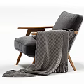 Stylish Gray Velvet Armchair With Wooden Armrests And Black White Striped Blanket Fringe