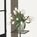 Transparent Glass Vase With White Tulips And Green Leaves On Gold Table