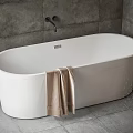 Modern White Bathtub Interior With Gray Tile Wall Brown Towel And Faucet