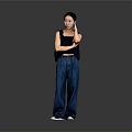 Stylish Woman In Black Top And Blue Jeans With Crossed Arms Standing Against Gray Background