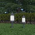 Outdoor Pillar Lights with White Lampshades on Grass and Trees Hedges Background