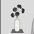 Minimalist White Vase With Green Flowers On Black Stand Against Beige Wall