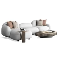 White Sectional Sofa with Brown and Beige Cushions and Side Coffee Tables with Magazines