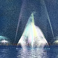 Colorful Night Fountain Display With Water Spray And Light Reflections On Water