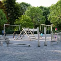 Outdoor Children's Play Area With Wooden Swings Climbing Frames And Trees