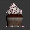 Chocolate Cupcake With White Frosting And Pink White Sprinkles On Black Background