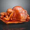 Wooden Sculpture Carving Of Curled Brown Figure With Detailed Texture Displayed On Dark Surface