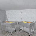 Two Stainless Steel Kitchen Utility Carts With Wheels Handle And Fresh Fruits On Top