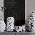 Blue And White Vases With Floral Patterns And Elephant Figurines On Decorative Shelf