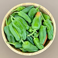Fresh Green Peppers In Wooden Bowl With Ripe Orange Tipped Varieties