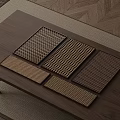 Wooden Coffee Table With Various Textured Metal Mesh Mats On Carpet And Wooden Floor