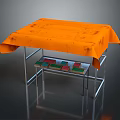Sturdy Table With Orange Tablecloth And Lower Metal Shelf Featuring Colorful Blocks