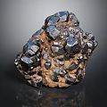 Natural Black Crystalline Stone With Metallic Luster And Brown Matrix