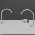 Brass and Gold Faucets on White Countertop with Dark Gray Yellow Wall and Marble Cube