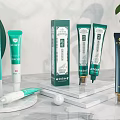 Perfume Cosmetics Skincare Creams And Serums With Green White Packaging On Marble Stand