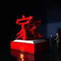 Garden Ornament Featuring Red Home Character On Pedestal With Two People