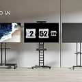 Iron Art Wheeled Floor Stands Supporting 60 Inch Screens In Modern Setting