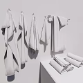 Light Green Towels Hanging On Hooks And Folded On White Countertop
