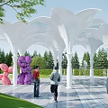 White Petal Shaped Pergola With Green Trees Sculptures And People Walking