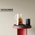 Designer Decorative Accessory Set With Glass Pitcher Black Cup On Red Table