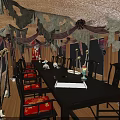 Gothic Dining Room With Wooden Ceiling Hanging Dark Fabrics Red Lanterns And Skull Ornaments