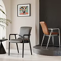 Black And Brown Dining Chairs On Display Platform Near Gray Wall With Colorful Painting