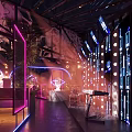 Modern Bar Interior with Neon Lights Sculpture Colorful Lighting and Seating Area