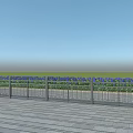 Metal Fence With Vertical Bars On Wooden Deck Overlooking Green Grass And Blue Sky