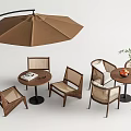Brown Outdoor Table With Rattan Chairs Umbrella And Green Plants
