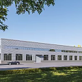 Modern Industrial Factory Exterior With Steel Structure Large Windows And Green Surroundings